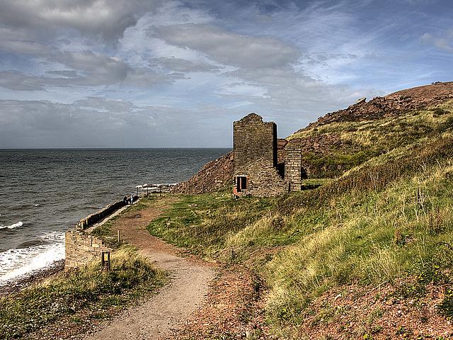 Bild einer Küste mit einer Ruine und Weg.