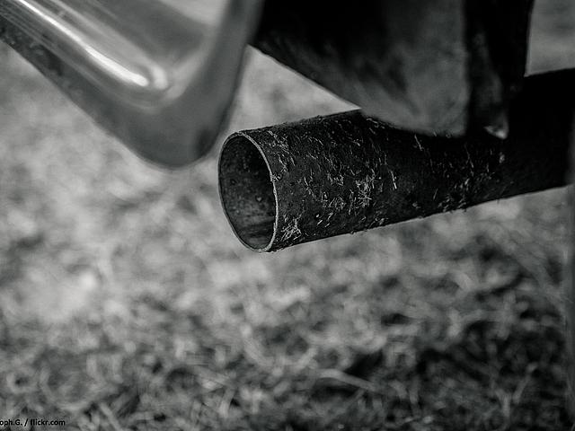 Foto: schwarz-weiß Bild eines Auspuffs am Auto.